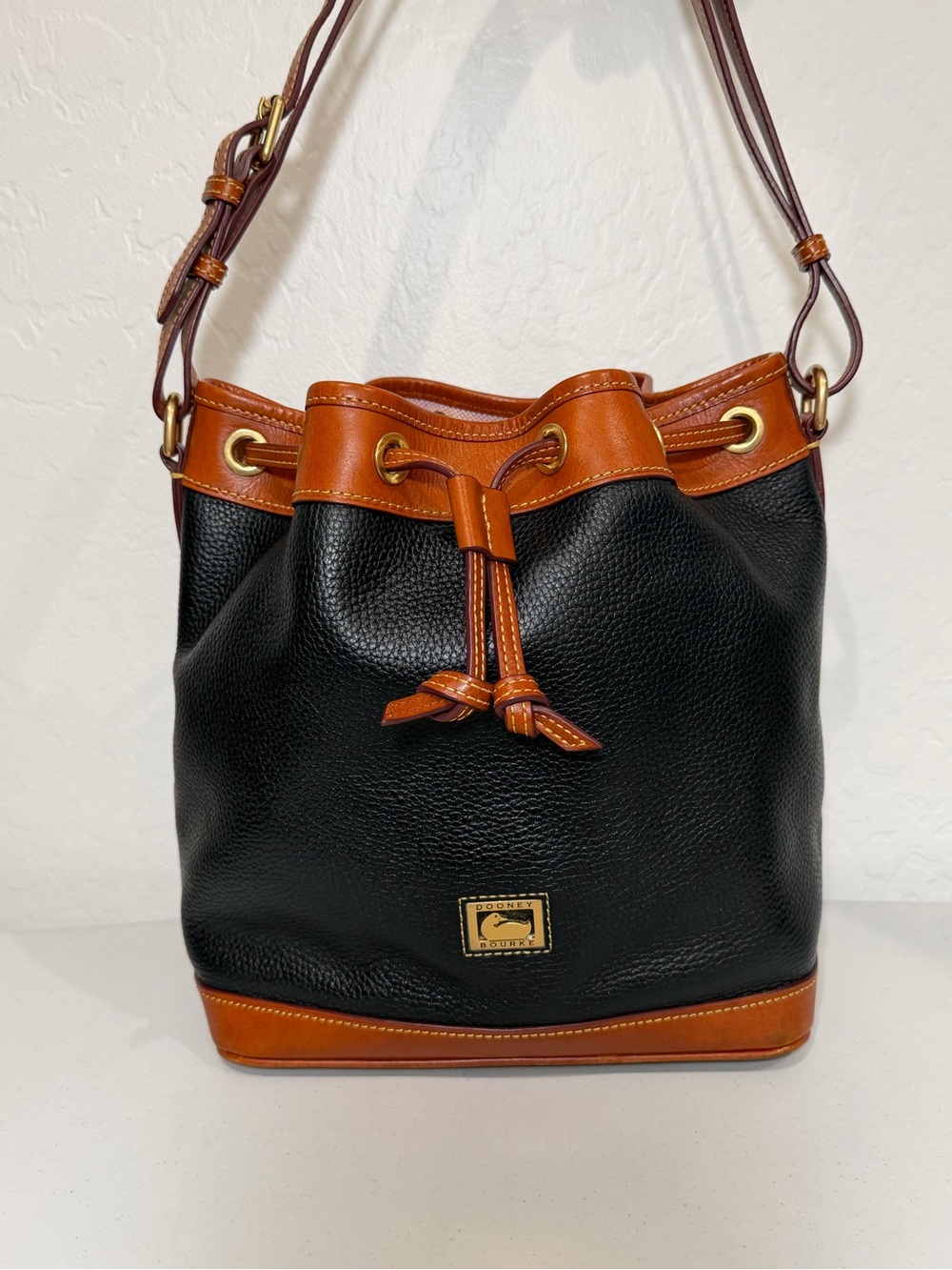 Dooney & Bourke Black and Brown Pebbled Leather Drawstring Shoulder Bag